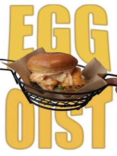 EGGoist sandwich in a wire basket over yellow type