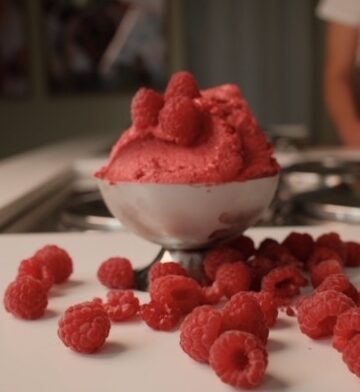 Raspberry sorbet among scattered raspberries